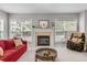 Cozy living room featuring a fireplace, large windows, and comfortable seating at 112 Natchez Ct, Cary, NC 27519