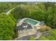 Aerial view of the community pool area with a distinct building and surrounding green spaces and trees at 112 Natchez Ct, Cary, NC 27519