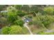An aerial view shows a white home in a wooded area with a long driveway and estimated property lines at 119 Johnson St, Broadway, NC 27505