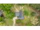 Aerial view of a home featuring a spacious backyard, driveway, and mature trees at 119 Johnson St, Broadway, NC 27505