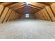 Spacious attic with a wood frame, wood floor, and a single window offering natural light at 119 Johnson St, Broadway, NC 27505