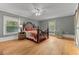 Spacious bedroom with hardwood floors, a ceiling fan, and natural light, perfect for restful nights at 119 Johnson St, Broadway, NC 27505