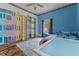 Unique bedroom showcasing hand-painted murals and wood laminate floors at 119 Johnson St, Broadway, NC 27505