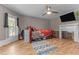Comfortable bedroom with a decorative fireplace and streaming television at 119 Johnson St, Broadway, NC 27505