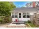 Inviting entrance with brick steps, a 'Welcome' sign, and a charming garden bed at 119 Johnson St, Broadway, NC 27505
