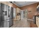 Spacious kitchen with stainless steel refrigerator and view of the adjacent rooms at 119 Johnson St, Broadway, NC 27505