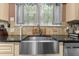 The kitchen sink features granite countertops, mosaic backsplash, and modern fixtures at 119 Johnson St, Broadway, NC 27505