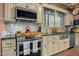 Well-lit kitchen featuring stainless steel appliances, granite counters, mosaic backsplash and ample storage at 119 Johnson St, Broadway, NC 27505