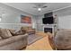 Spacious living room featuring hardwood floors, comfortable seating, fireplace and a vintage feel at 119 Johnson St, Broadway, NC 27505