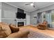 Bright living room with fireplace, hardwood floors, and comfortable seating near natural light at 119 Johnson St, Broadway, NC 27505