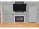 Living room boasts hardwood floors, a fireplace, and a flat screen TV, great for relaxing and entertaining at 119 Johnson St, Broadway, NC 27505