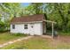Exterior view of the shed. The shed has a white door with a covered area at 119 Johnson St, Broadway, NC 27505