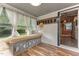 Bright sunroom with a cozy seating area and views of the lush greenery outside at 119 Johnson St, Broadway, NC 27505