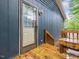 Side entrance to the home with wooden deck and a wooden bench at 1204 Hydrangea Ct, Hillsborough, NC 27278