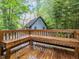 Wide wooden back porch overlooking the lush backyard at 1204 Hydrangea Ct, Hillsborough, NC 27278