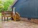Back porch with wooden railings and stairs leading to the side yard at 1204 Hydrangea Ct, Hillsborough, NC 27278