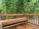 Wooden back porch with built in bench, and bamboo background at 1204 Hydrangea Ct, Hillsborough, NC 27278
