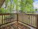 Scenic backyard view from the wooden deck, with lush greenery and other houses visible at 1204 Hydrangea Ct, Hillsborough, NC 27278