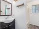 Bathroom with sink, vanity, wood shelves and shower-tub combo at 1204 Hydrangea Ct, Hillsborough, NC 27278