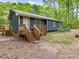 Inviting home with a wooden porch, steps leading up to the entrance at 1204 Hydrangea Ct, Hillsborough, NC 27278