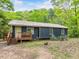 Cozy one-story home featuring a small front porch and surrounded by lush greenery at 1204 Hydrangea Ct, Hillsborough, NC 27278