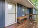 Welcoming front porch with wooden bench, perfect for enjoying the outdoors at 1204 Hydrangea Ct, Hillsborough, NC 27278