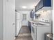 Well-lit kitchen with white appliances and dark blue cabinets at 1204 Hydrangea Ct, Hillsborough, NC 27278