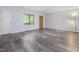 Spacious living room showcasing sleek vinyl floors, a door, and ample natural light at 1204 Hydrangea Ct, Hillsborough, NC 27278