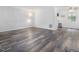 Bright living room featuring hardwood floors, white walls, and natural light at 1204 Hydrangea Ct, Hillsborough, NC 27278