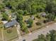 Sprawling property showcasing a home with mature trees, landscaping, and a long driveway at 1213 Walnut St, Cary, NC 27511