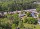 Aerial view showcases wooded lot and well-maintained landscaping near a busy road at 1213 Walnut St, Cary, NC 27511