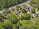 Aerial view of neighborhood with mature trees and spacious lots near a roadway at 1213 Walnut St, Cary, NC 27511