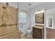 Tiled bathroom with glass shower enclosure and granite topped vanity at 1213 Walnut St, Cary, NC 27511