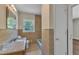 A well-lit bathroom with modern tiling and granite countertop at 1213 Walnut St, Cary, NC 27511