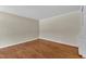 Bedroom with hardwood floors, neutral walls, and minimalist trim at 1213 Walnut St, Cary, NC 27511