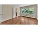 Bedroom with hardwood floors, closet, and natural light from a large window at 1213 Walnut St, Cary, NC 27511