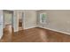 Empty bedroom featuring hardwood floors, neutral paint, and a single window at 1213 Walnut St, Cary, NC 27511