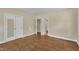 Empty bedroom featuring hardwood floors, neutral paint, and two closets at 1213 Walnut St, Cary, NC 27511