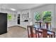 Bright kitchen featuring white cabinets, tile floors, and a dining area with views of the backyard at 1213 Walnut St, Cary, NC 27511