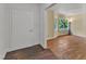 Empty living room featuring hardwood floors, neutral paint, and corner window at 1213 Walnut St, Cary, NC 27511