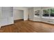 Living room featuring hardwood floors, natural lighting, and built in shelving at 1213 Walnut St, Cary, NC 27511