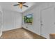A paneled room with ceiling fan and a window that overlooks a deck at 1213 Walnut St, Cary, NC 27511