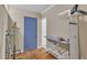 Room with an ironing board, hanging clothes, and blue trim on the walls and door at 1213 Walnut St, Cary, NC 27511