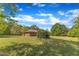 Scenic view of the home's expansive yard with mature trees providing ample shade and privacy at 1213 Walnut St, Cary, NC 27511