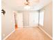 Neutral bedroom with tan carpet, ceiling fan, closet, interior door, and a window providing natural light at 122 American Rd, Timberlake, NC 27583