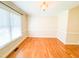 Inviting dining room featuring gleaming hardwood floors, a large window, and elegant trim at 122 American Rd, Timberlake, NC 27583