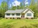 Charming single-story home with a well-manicured lawn, mature trees and blue shutters at 122 American Rd, Timberlake, NC 27583