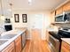 Open kitchen with stainless steel appliances, light countertops, and a view to the living space at 122 American Rd, Timberlake, NC 27583