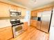 Bright kitchen features stainless steel appliances, light countertops, and wood cabinets at 122 American Rd, Timberlake, NC 27583