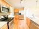 Modern kitchen with stainless steel appliances, light wood cabinetry, and hardwood floors at 122 American Rd, Timberlake, NC 27583
